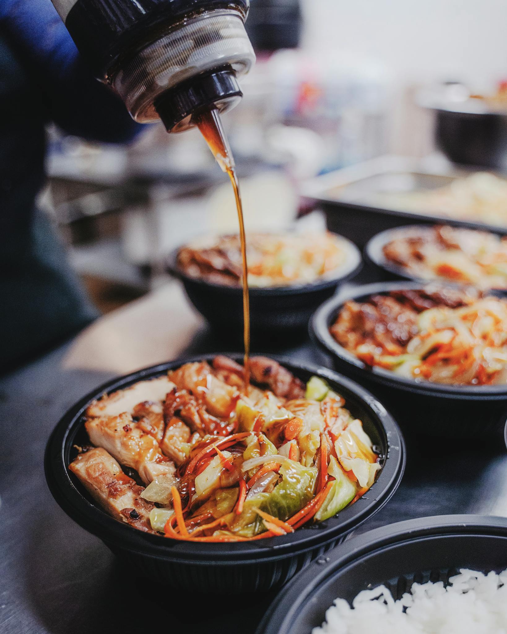 Flavorful Korean chicken rice bowl drizzled with rich sauce, capturing the essence of Asian cuisine.