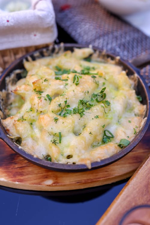 Creamy gluten-free mac and cheese served in a bowl with melted cheese